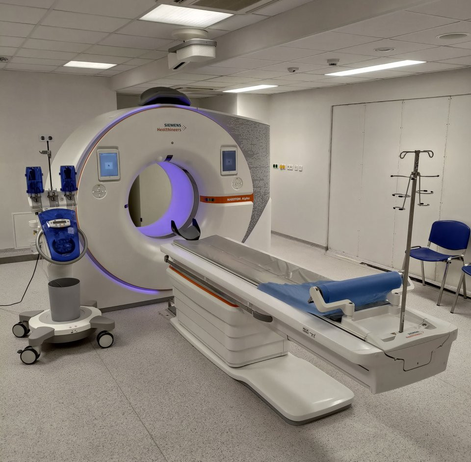 Modern photon-counting CT scanner in a clinical room, equipment-only.