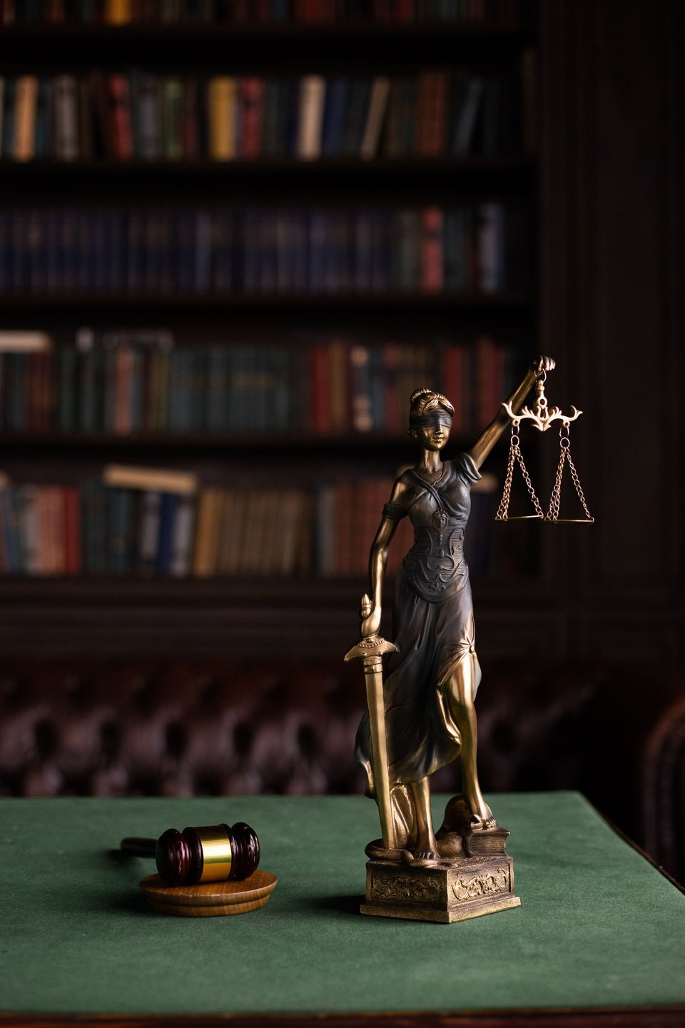 Lady Justice and a gavel in a law library.