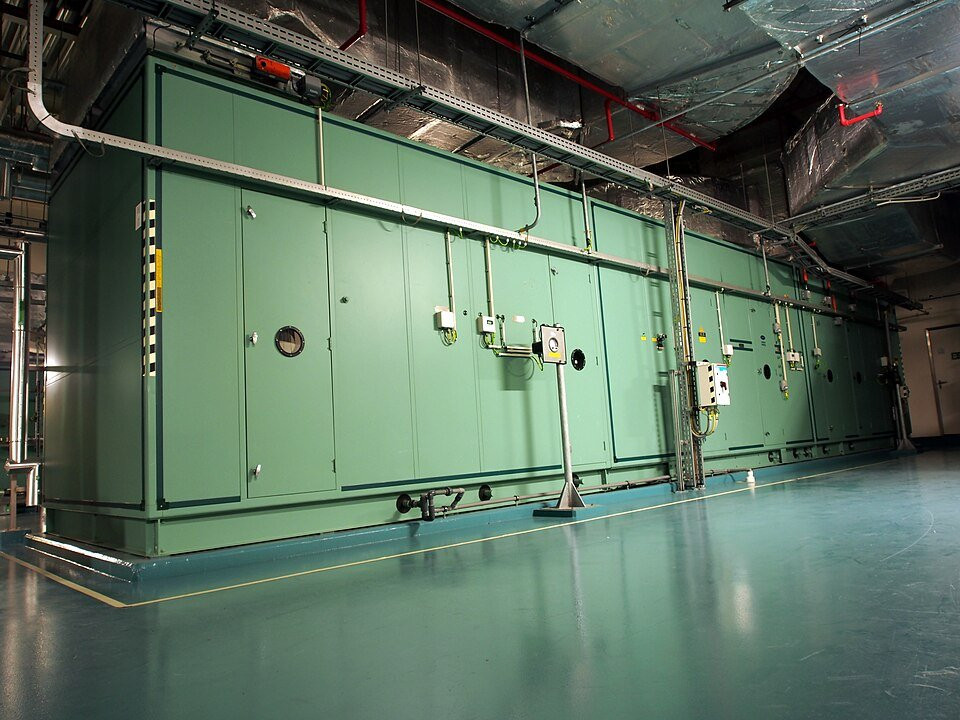 Industrial air-handling unit with ducts and control connections.