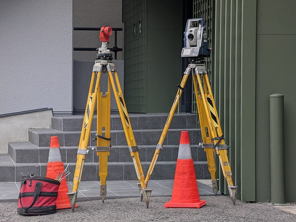 Surveying prism and total station used for land measurement.