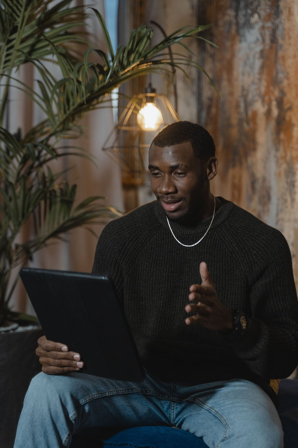 Man using a tablet for an online conversation.