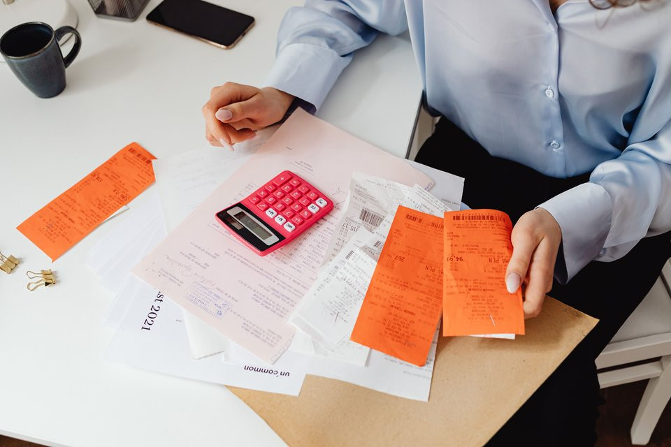 Receipts and a calculator being used to review expenses.